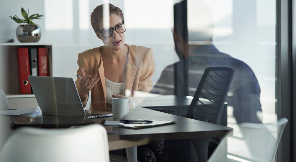 Female manager meets with male team member about their wellbeing